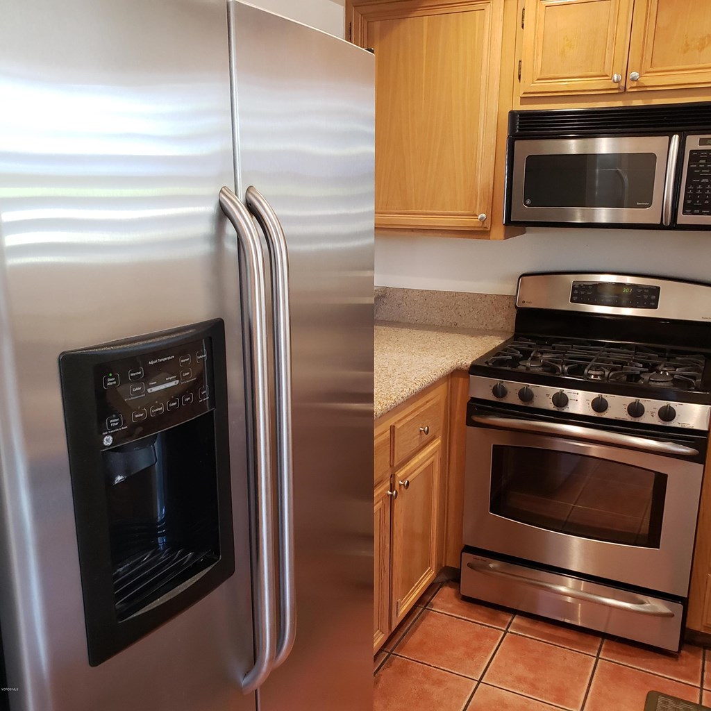 2731 Erringer Road, Unit 71 Simi Valley, CA 93065 - Photo 4 of 45 a kitchen with granite countertop stainless steel appliances and wooden cabinets