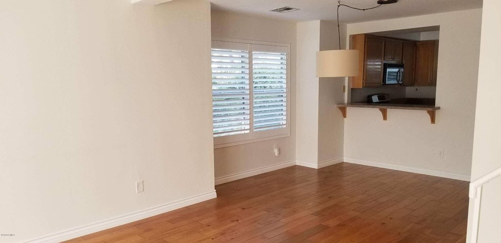 2731 Erringer Road, Unit 71 Simi Valley, CA 93065 - Photo 39 of 45 a view of a livingroom with wooden floor and a window