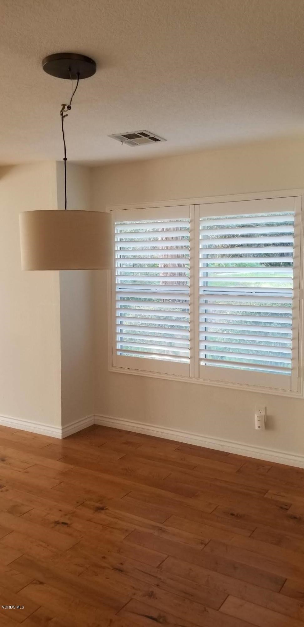 2731 Erringer Road, Unit 71 Simi Valley, CA 93065 - Photo 40 of 45 a view of an empty room with wooden floor and a window