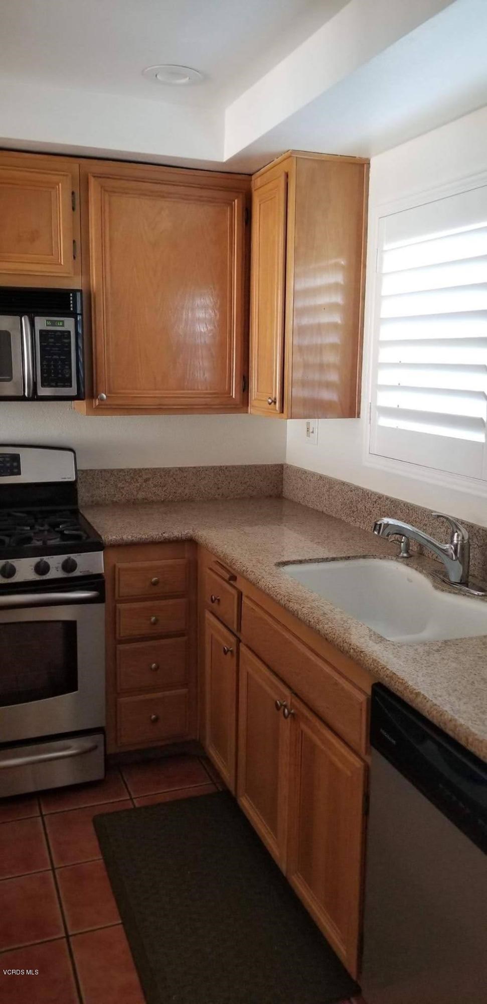 2731 Erringer Road, Unit 71 Simi Valley, CA 93065 - Photo 7 of 45 a kitchen with a sink stove and microwave