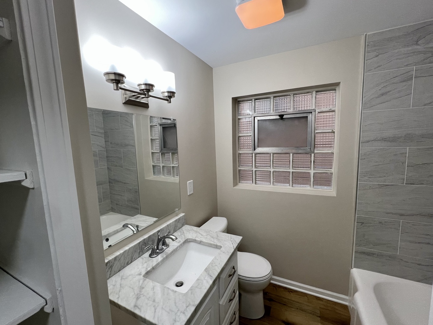1515 Maple Avenue, Unit 1 Berwyn, IL 60402 - Photo 12 of 12 a bathroom with a sink toilet and shower