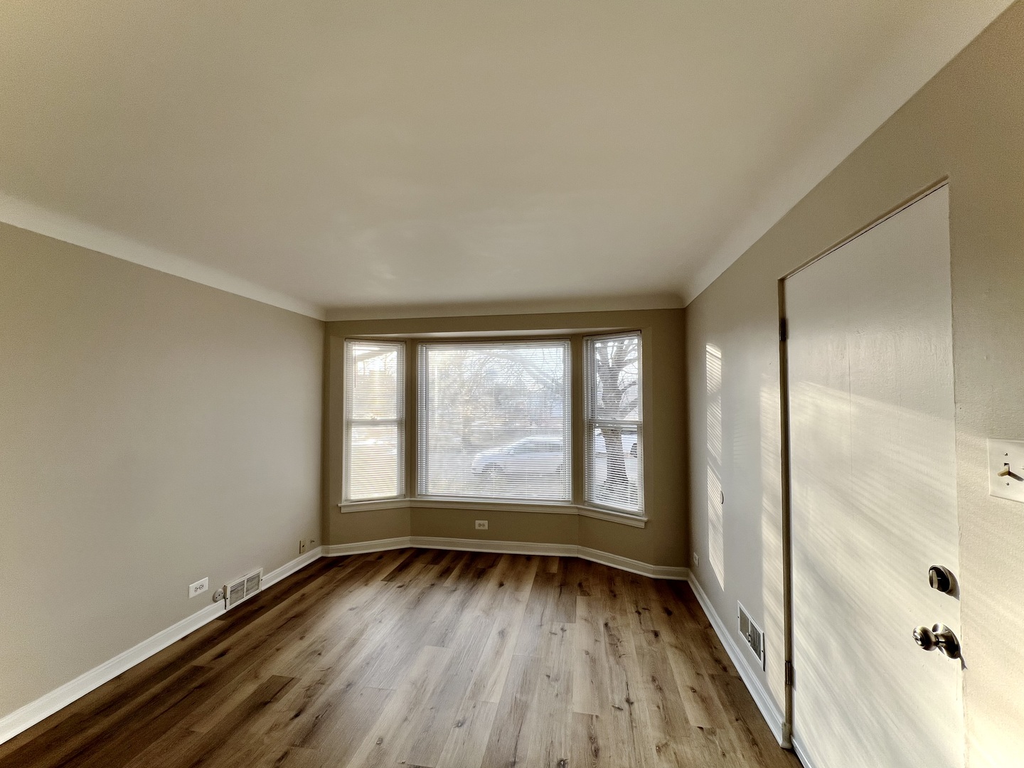 1515 Maple Avenue, Unit 1 Berwyn, IL 60402 - Photo 4 of 12 wooden floor in an empty room with a window