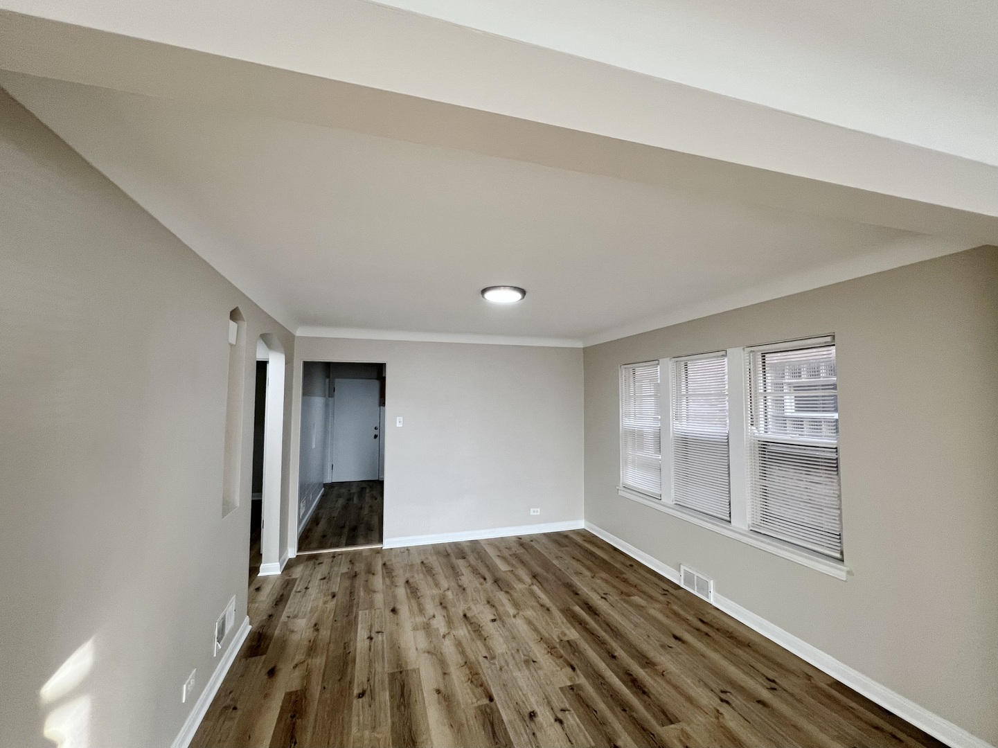 1515 Maple Avenue, Unit 1 Berwyn, IL 60402 - Photo 5 of 12 a view of empty room with wooden floor and fan