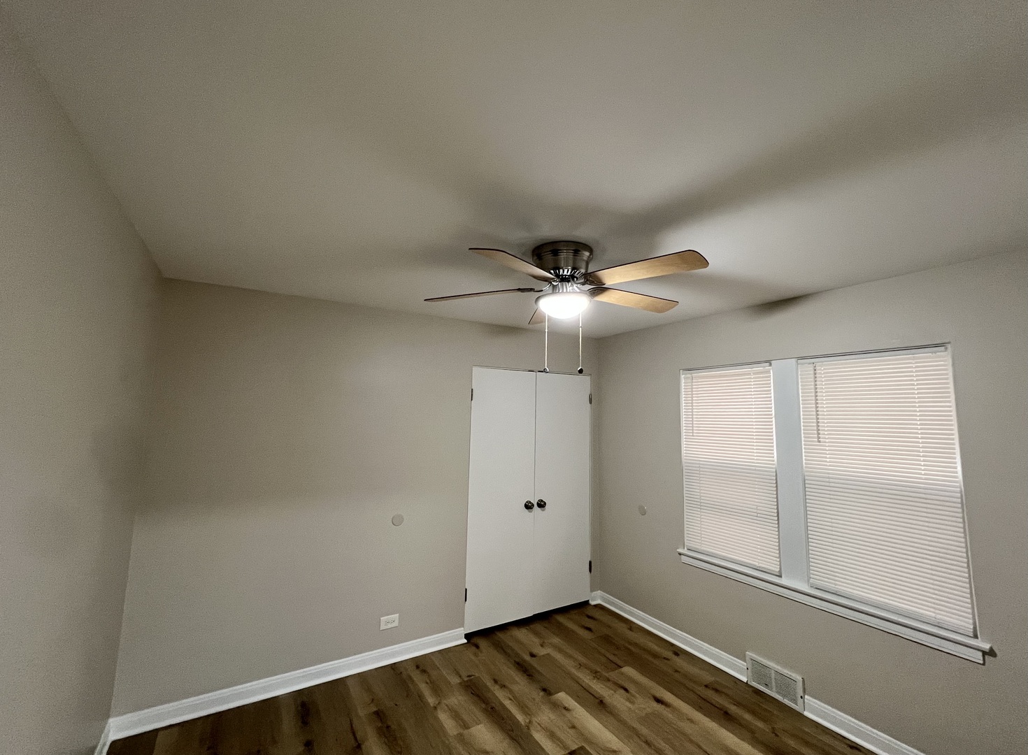 1515 Maple Avenue, Unit 1 Berwyn, IL 60402 - Photo 7 of 12 an empty room with windows and fan