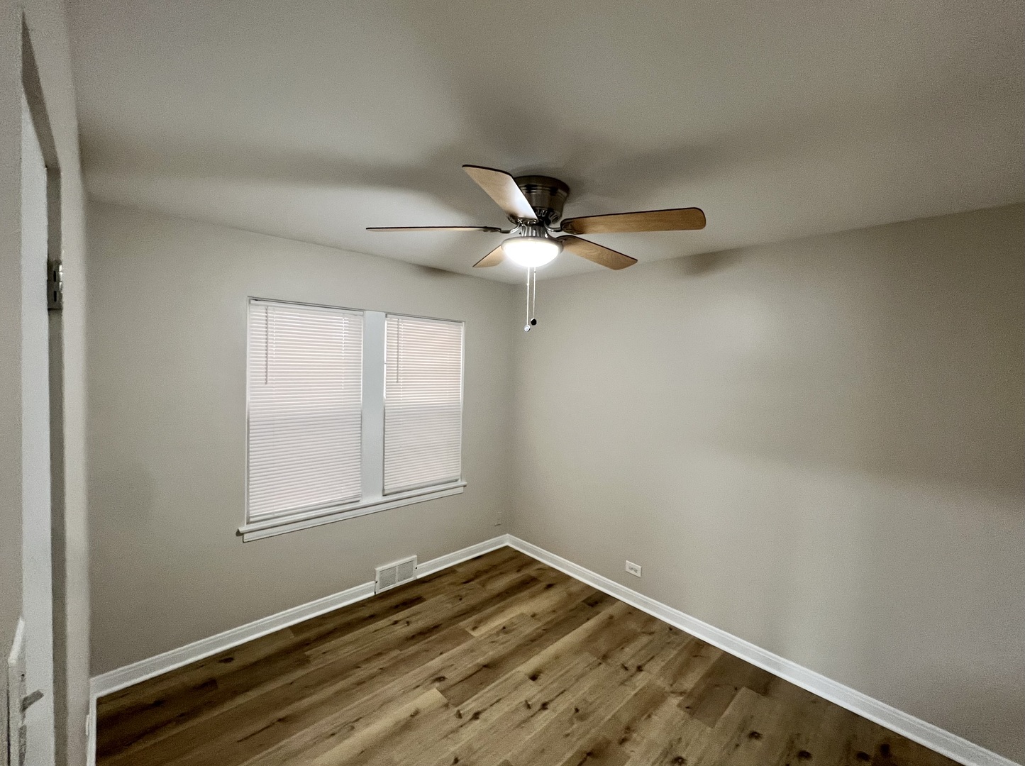 1515 Maple Avenue, Unit 1 Berwyn, IL 60402 - Photo 10 of 12 an empty room with a window and ceiling fan