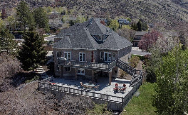1085 Windsor Drive Provo, UT 84604 - Photo 7 of 83 Back of property featuring a fenced backyard, roof with shingles, a deck, and a patio area with amazing views