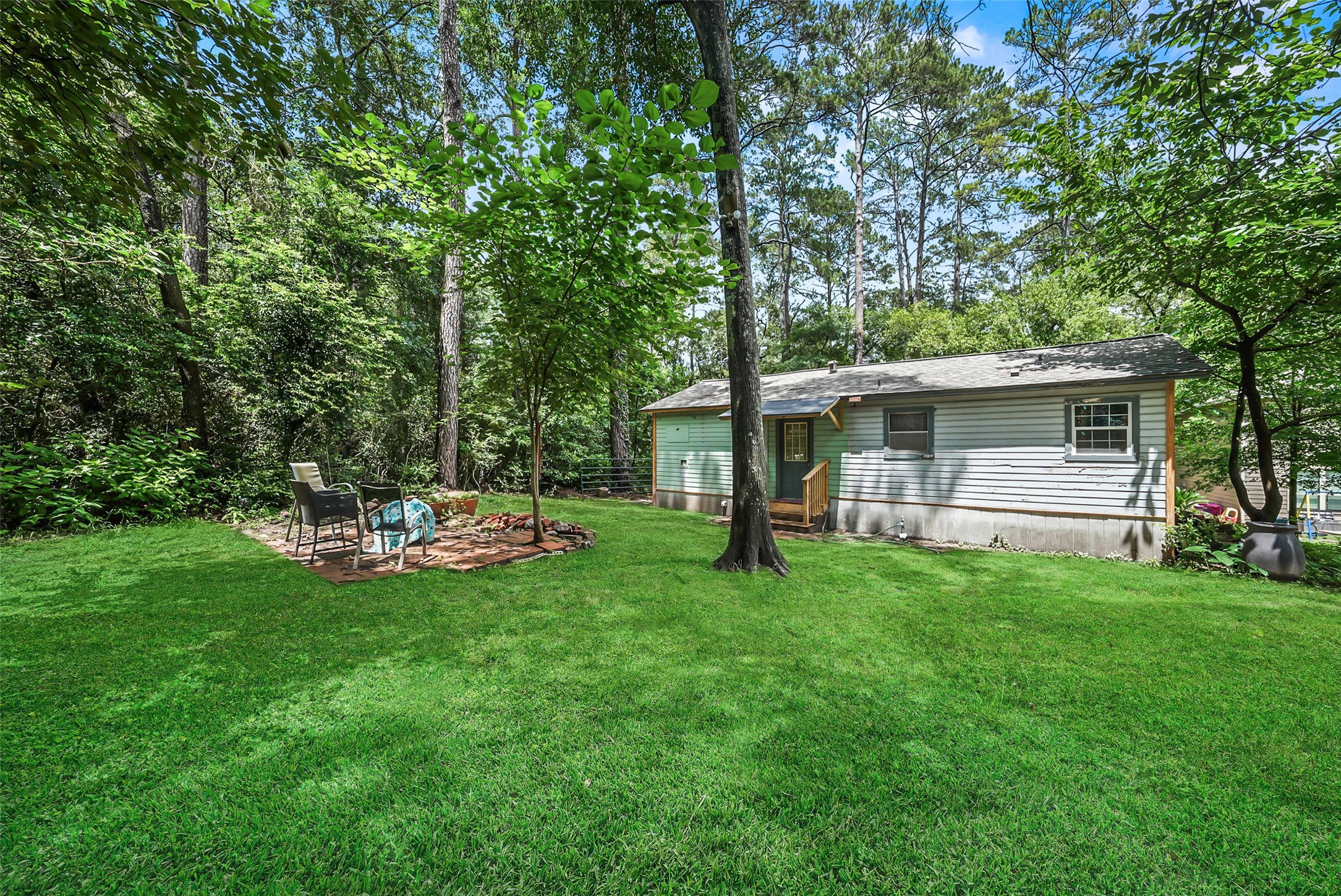 6387 Oak Knoll Road Montgomery, TX 77316 - Photo 3 of 30 a view of a house with backyard sitting area and garden