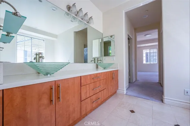 a bathroom with a double vanity sink and a mirror
