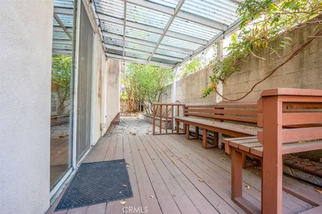 a view of deck with table and chairs and wooden floor