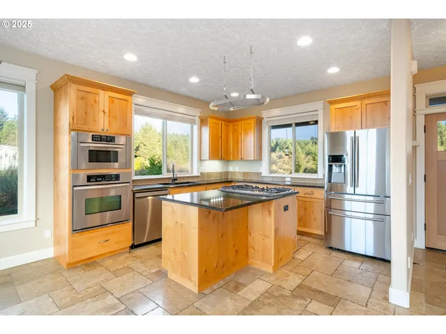 a kitchen with granite countertop a sink and cabinets