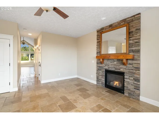 a living room with a fireplace and a floor to ceiling window