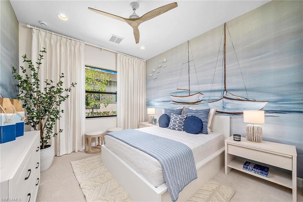 12797 Springbrook Court Estero, FL 33928 - Photo 12 of 30 a bedroom with a large bed and a chandelier