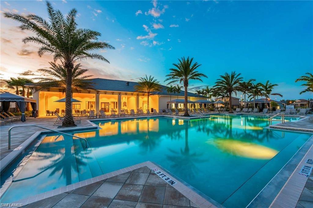12797 Springbrook Court Estero, FL 33928 - Photo 26 of 30 a view of swimming pool with outdoor seating and lake view
