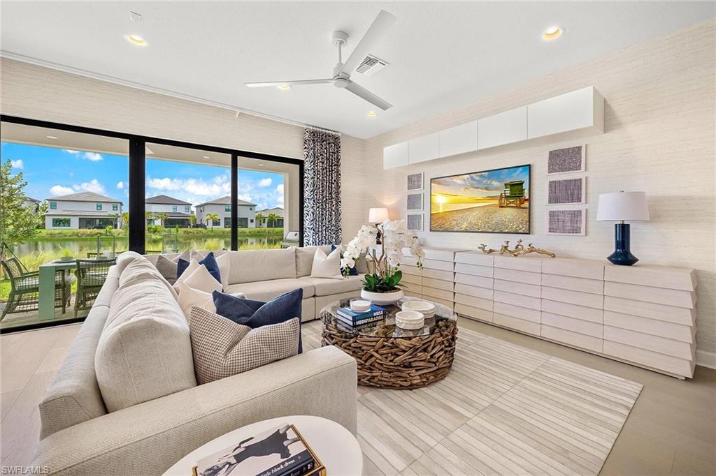 12797 Springbrook Court Estero, FL 33928 - Photo 6 of 30 a living room with furniture large window and flat screen tv