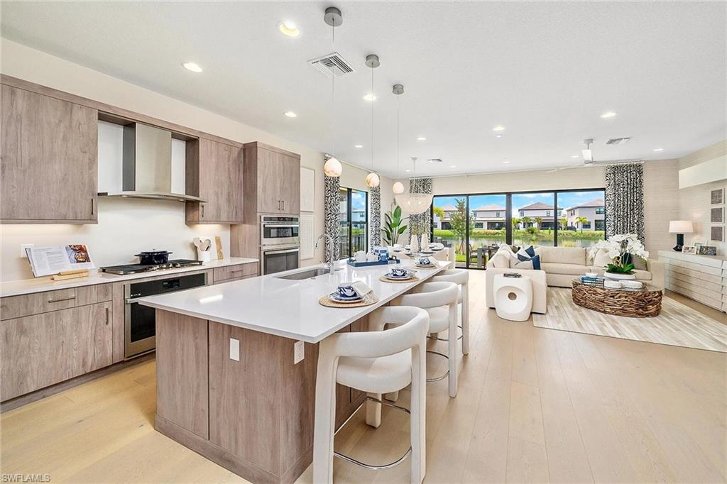 12797 Springbrook Court Estero, FL 33928 - Photo 8 of 30 a kitchen with counter top space a sink cabinets and appliances