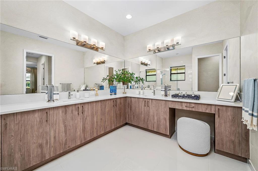12797 Springbrook Court Estero, FL 33928 - Photo 10 of 30 a bathroom with a sink double vanity and a mirror