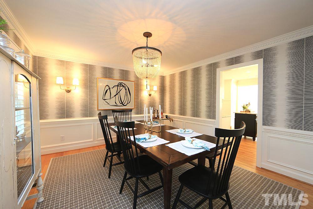 7828 Hardwick Drive Raleigh, NC 27615 - Photo 13 of 25 a view of a a dining room with furniture window and wooden floor