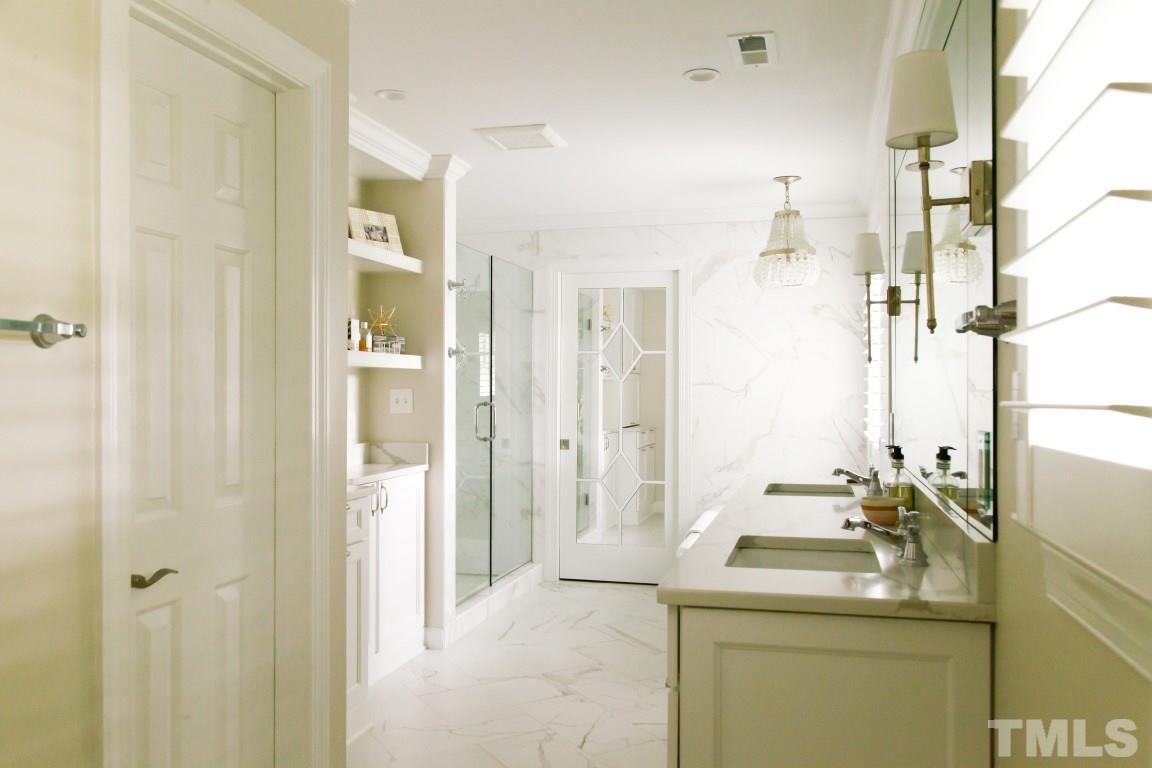 7828 Hardwick Drive Raleigh, NC 27615 - Photo 16 of 25 a bathroom with a sink and a mirror
