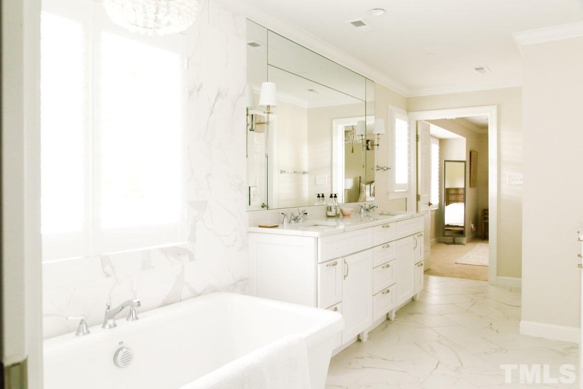 7828 Hardwick Drive Raleigh, NC 27615 - Photo 17 of 25 a bathroom with a tub sink and mirror