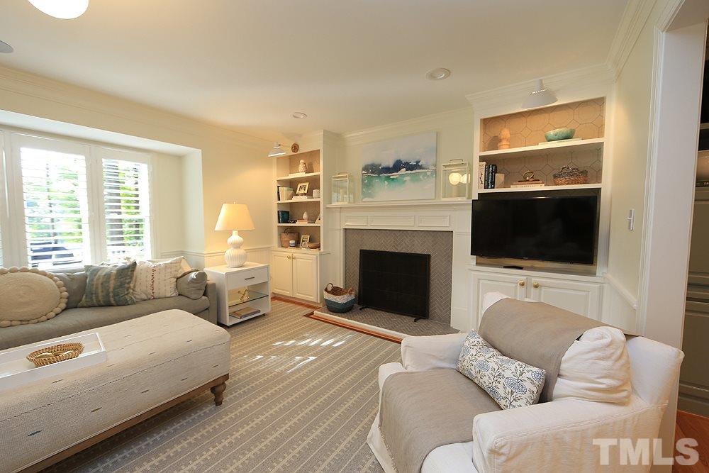 7828 Hardwick Drive Raleigh, NC 27615 - Photo 5 of 25 a living room with furniture flat screen tv and a fireplace