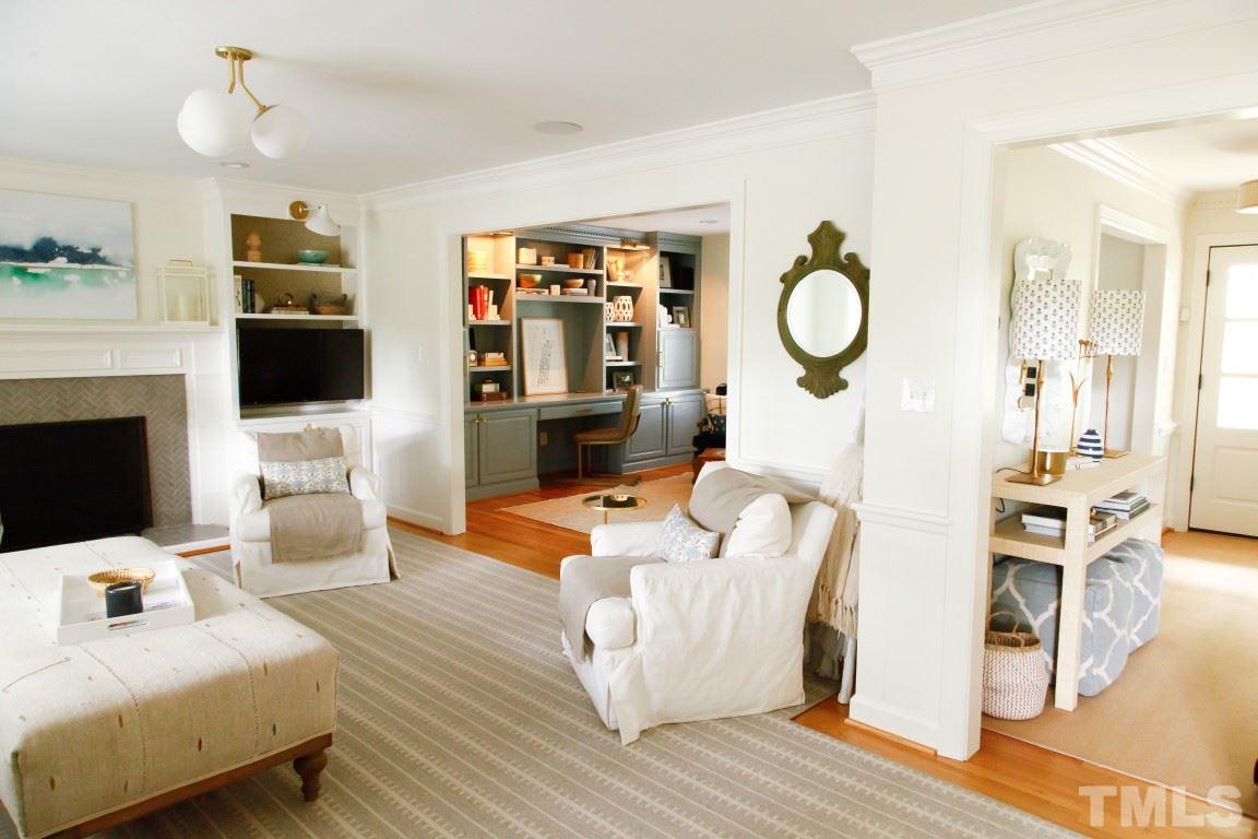 7828 Hardwick Drive Raleigh, NC 27615 - Photo 7 of 25 a living room with furniture a flat screen tv and a fireplace