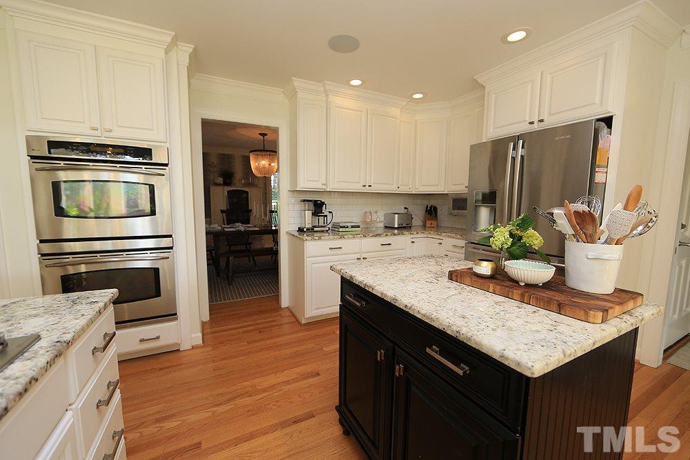 7828 Hardwick Drive Raleigh, NC 27615 - Photo 9 of 25 a kitchen with a center island appliances and cabinets