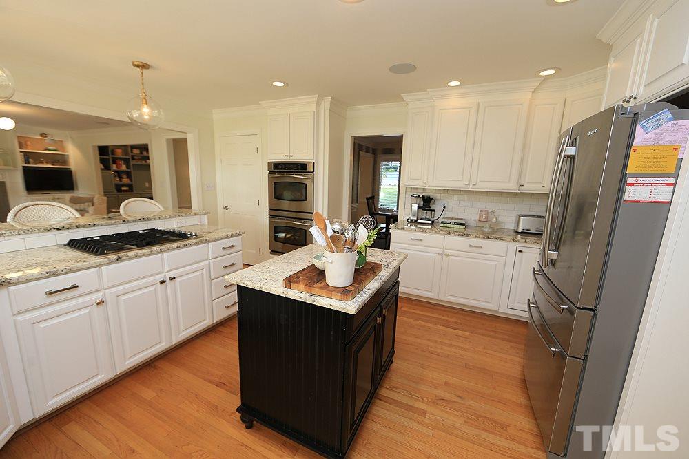 7828 Hardwick Drive Raleigh, NC 27615 - Photo 10 of 25 a kitchen with a sink a counter top space stainless steel appliances and cabinets