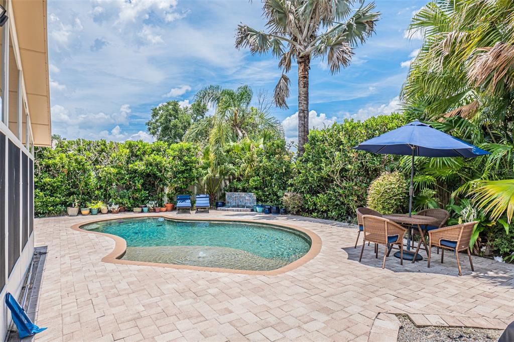 741 Brookside Road Maitland, FL 32751 - Photo 43 of 43 a view of a swimming pool with a table and chairs under an umbrella