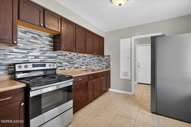 a kitchen with stainless steel appliances granite countertop a stove and a refrigerator