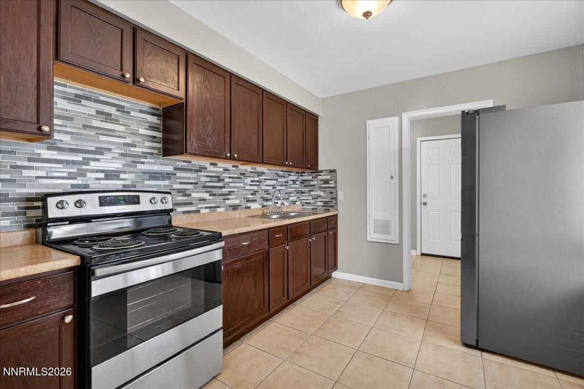 1339 Locust Street Reno, NV 89502 - Photo 12 of 23 a kitchen with stainless steel appliances granite countertop a stove and a refrigerator
