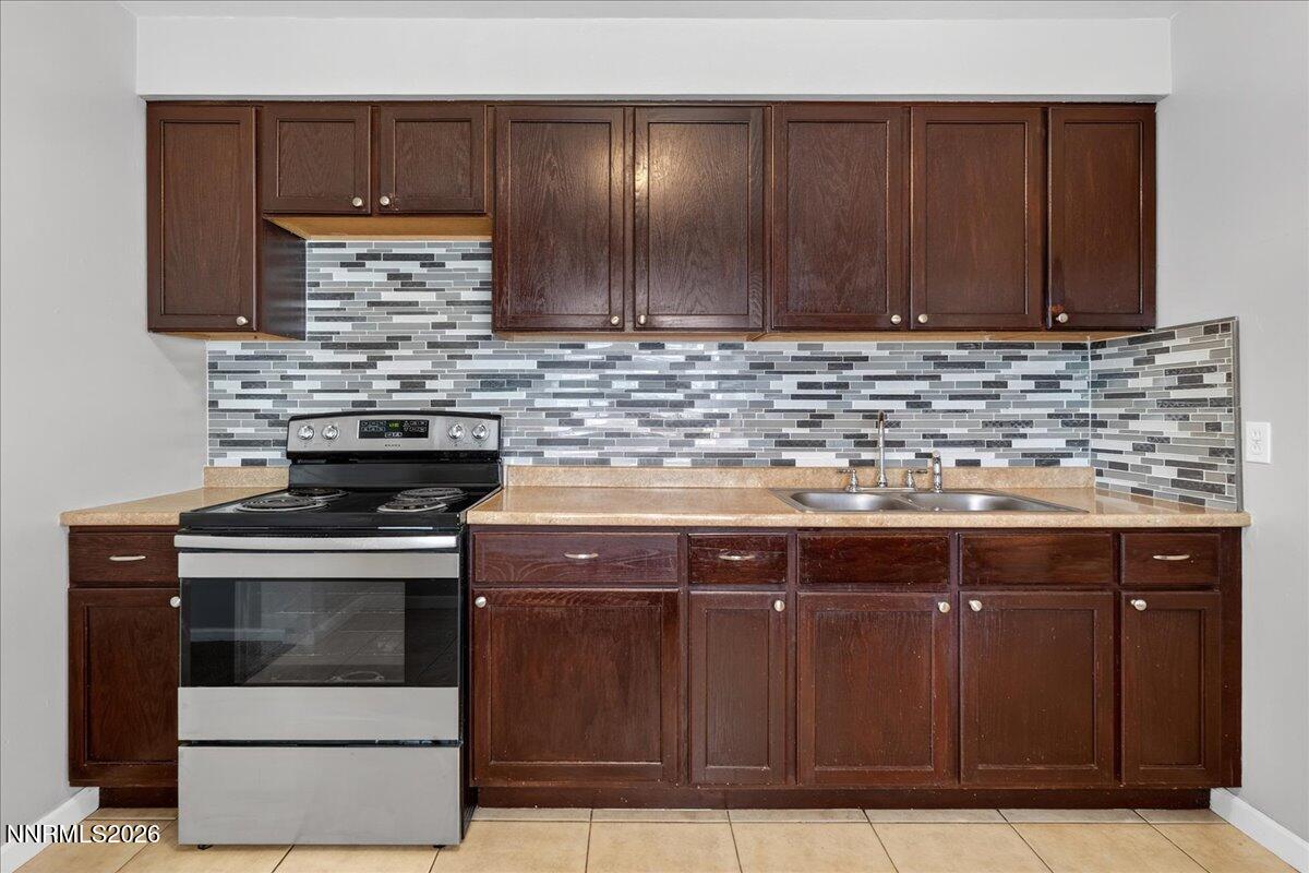 1339 Locust Street Reno, NV 89502 - Photo 13 of 23 a kitchen with granite countertop a stove top oven cabinets and stainless steel appliances