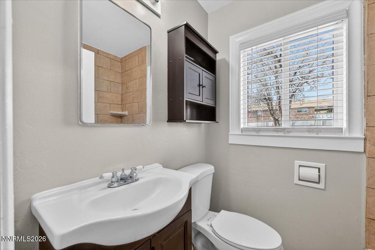 1339 Locust Street Reno, NV 89502 - Photo 16 of 23 a bathroom with a sink a toilet and mirror