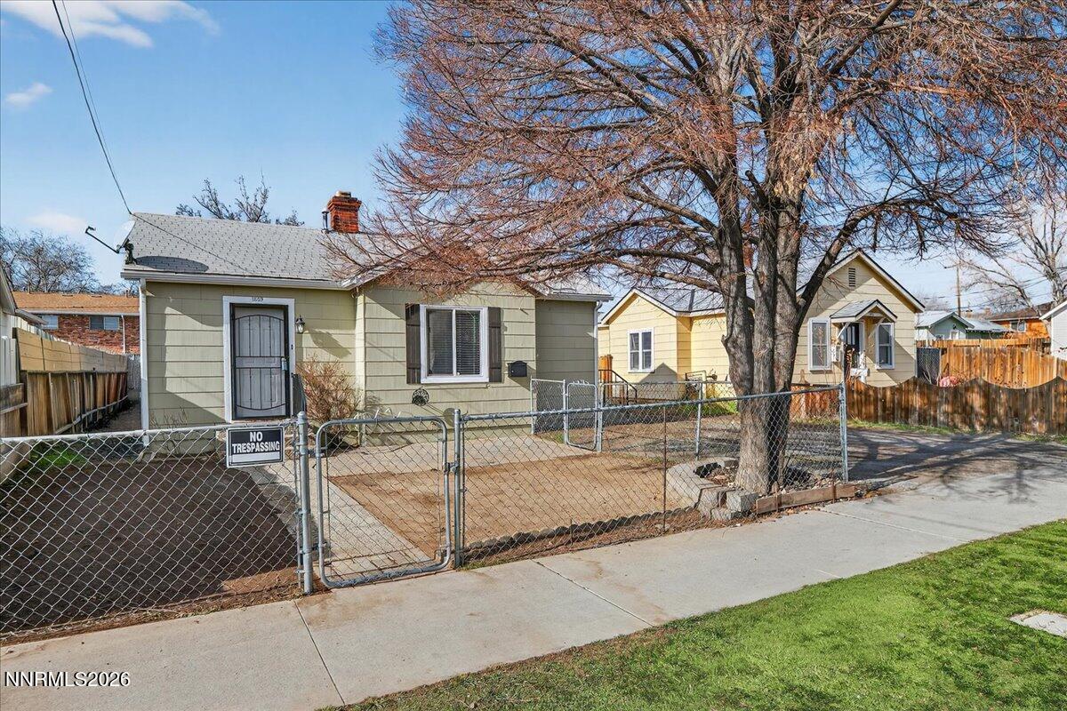 1339 Locust Street Reno, NV 89502 - Photo 3 of 23 a view of a white house with a patio and a yard