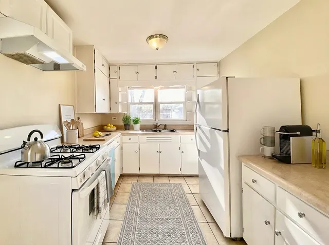 a kitchen that has a sink cabinets and a stove