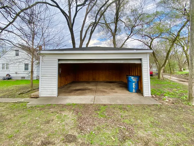 a view of a house with a yard and garage