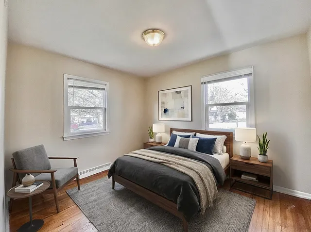 a bedroom with a bed and wooden floor