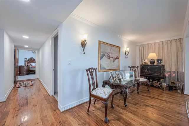 a kitchen with stainless steel appliances kitchen island granite countertop a table chairs and a refrigerator
