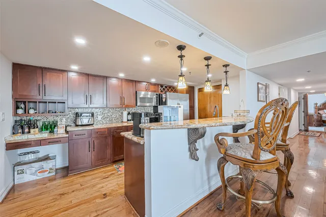 a kitchen with stainless steel appliances granite countertop a sink and cabinets