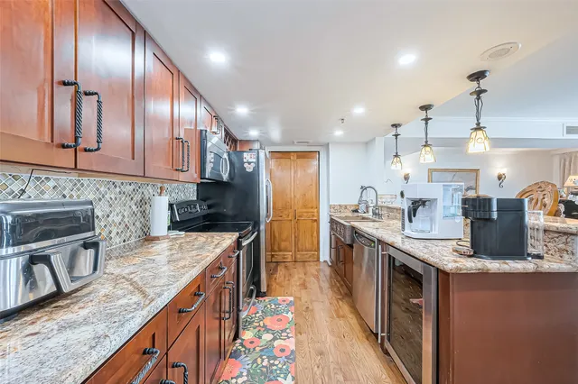 a kitchen with granite countertop a sink and a stove