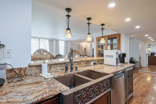 a bathroom with a granite countertop shower sink vanity and toilet