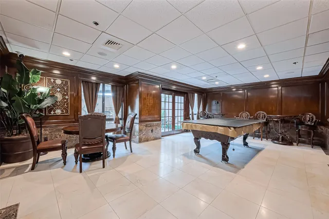 a bed sitting in a spacious bedroom next to a window