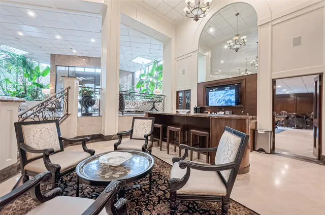 a living room with furniture and a chandelier