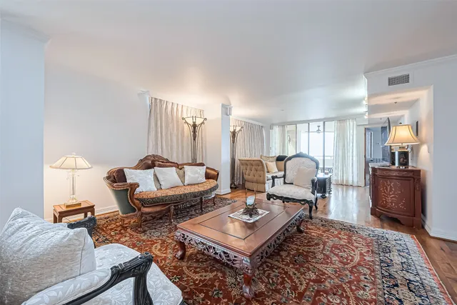 a living room with furniture a rug and a window