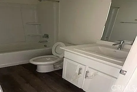 a bathroom with a toilet sink a mirror and shower