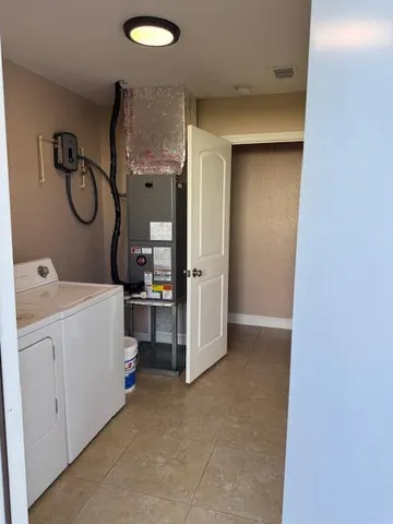 a room with a chandelier and a rug