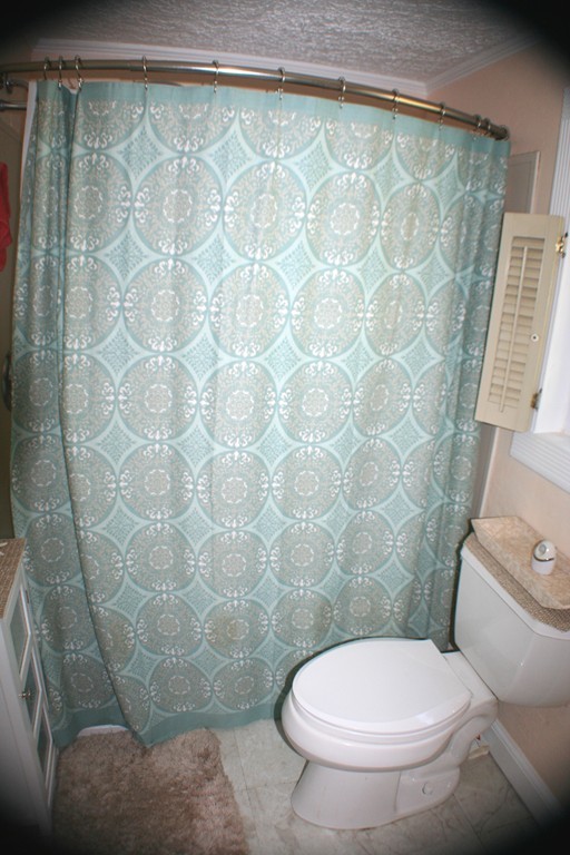 39 Lathrop Road Bourne, MA 02562 - Photo 11 of 22 a white toilet sitting next to a shower curtain