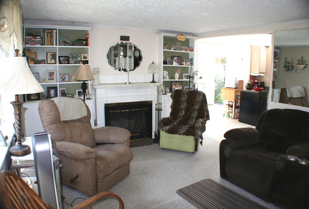 39 Lathrop Road Bourne, MA 02562 - Photo 6 of 22 a living room with furniture and a fireplace