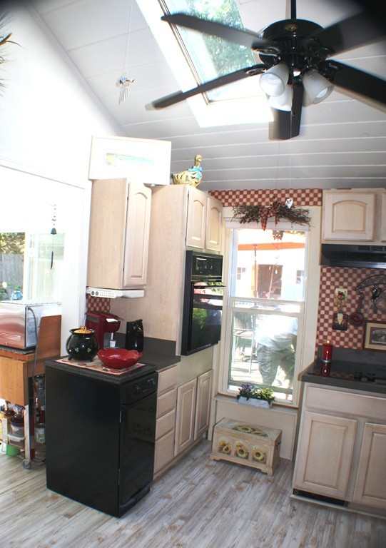 39 Lathrop Road Bourne, MA 02562 - Photo 9 of 22 a kitchen with stainless steel appliances kitchen island granite countertop a sink dishwasher stove and white cabinets