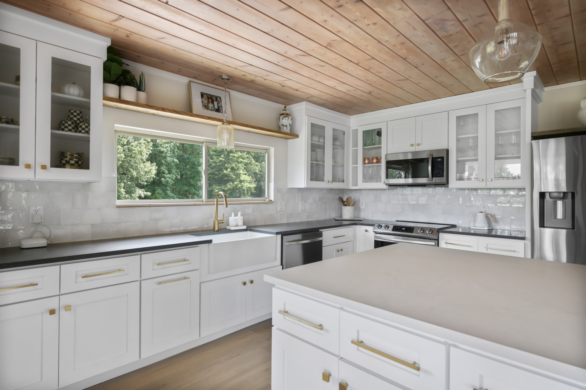 7720 Smith Road Primm Springs, TN 38476 - Photo 13 of 58 a kitchen with stainless steel appliances granite countertop a sink a stove cabinets and a window