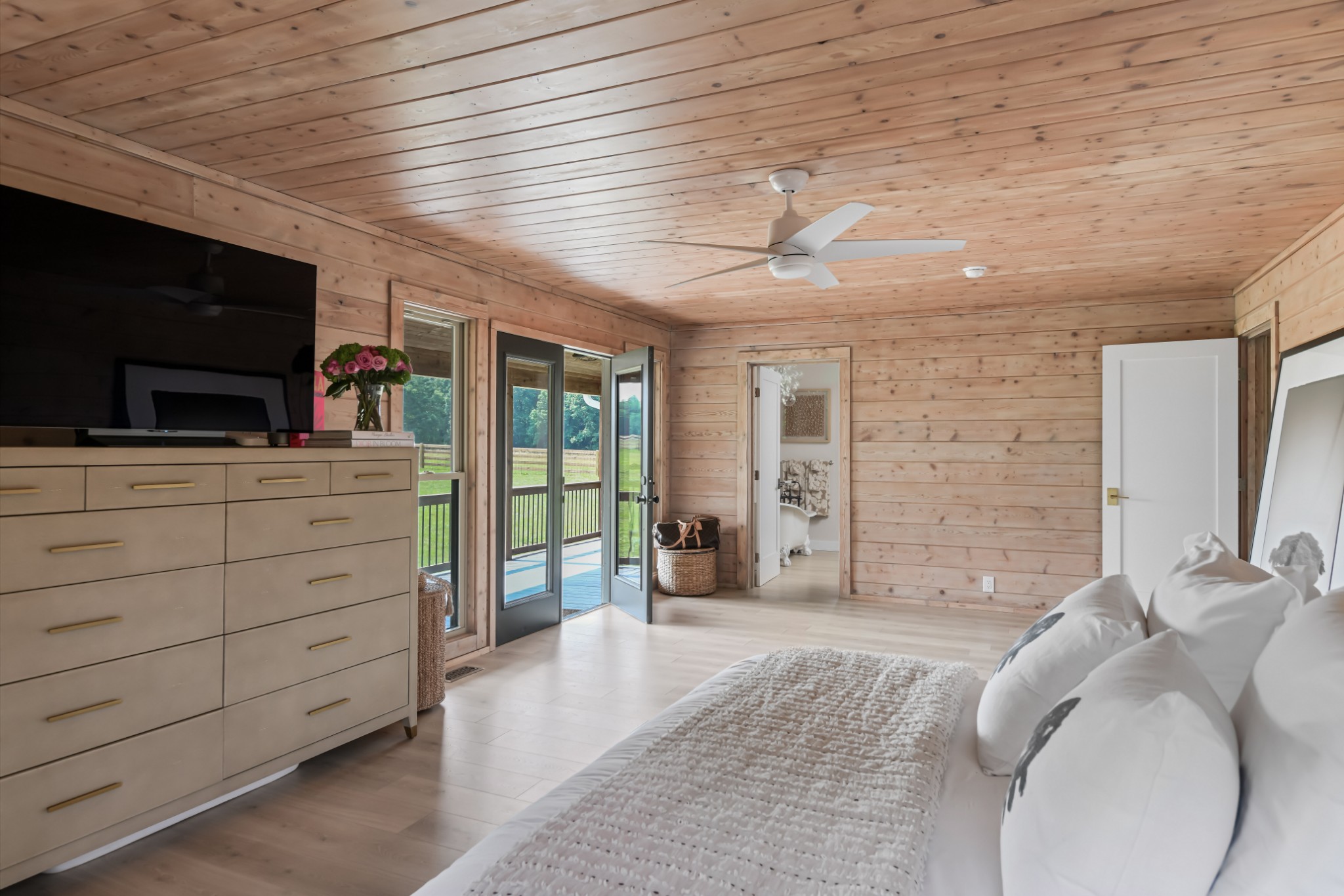 7720 Smith Road Primm Springs, TN 38476 - Photo 20 of 58 a spacious bedroom with a bed and a flat screen tv